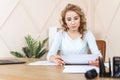 Businesswoman sitting in office and checking documents Royalty Free Stock Photo