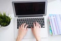 Businesswoman sitting at office desk and typing on a laptop hands close up. View from above. Royalty Free Stock Photo