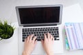 Businesswoman sitting at office desk and typing on a laptop hands close up. View from above. Royalty Free Stock Photo