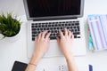 Businesswoman sitting at office desk and typing on a laptop hands close up. View from above. Royalty Free Stock Photo