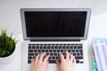 Businesswoman sitting at office desk and typing on a laptop hands close up. View from above. Royalty Free Stock Photo