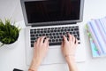 Businesswoman sitting at office desk and typing on a laptop hands close up. View from above. Royalty Free Stock Photo