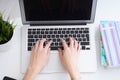 Businesswoman sitting at office desk and typing on a laptop hands close up. View from above. Royalty Free Stock Photo