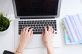 Businesswoman sitting at office desk and typing on a laptop hands close up. View from above. Royalty Free Stock Photo