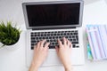 Businesswoman sitting at office desk and typing on a laptop hands close up. View from above. Royalty Free Stock Photo