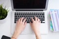 Businesswoman sitting at office desk and typing on a laptop hands close up. View from above. Royalty Free Stock Photo