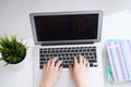 Businesswoman sitting at office desk and typing on a laptop hands close up. View from above. Royalty Free Stock Photo