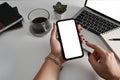 Businesswoman sitting at office desk working wit laptop and using mobile phone. Royalty Free Stock Photo