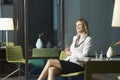 Businesswoman Sitting In Office And Smiling