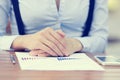 Businesswoman sitting at table in front of financial document Royalty Free Stock Photo