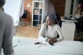 Businesswoman sitting at the table and listening to the client`s offer Royalty Free Stock Photo