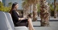 Businesswoman sitting working in an urban park Royalty Free Stock Photo