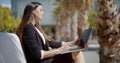 Businesswoman sitting working in an urban park Royalty Free Stock Photo