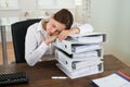 Businesswoman Sleeping On Stack Of Folders Royalty Free Stock Photo