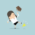 Businesswoman slipping on a banana peel and falling down. Royalty Free Stock Photo