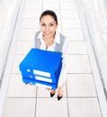 Businesswoman smile, hold blue stack folder Royalty Free Stock Photo