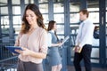 Businesswoman smiling at camera while her colleagues discussing in background Royalty Free Stock Photo