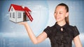 Businesswoman smiling and holding house in hand Royalty Free Stock Photo