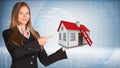 Businesswoman smiling and holding house in hand Royalty Free Stock Photo