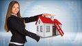 Businesswoman smiling and holding house in hand Royalty Free Stock Photo