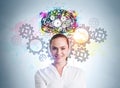 Businesswoman smiling portrait, gears and colourful brain sketch on blue wall Royalty Free Stock Photo