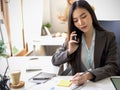 Businesswoman speaking on the phone in her office workplace Royalty Free Stock Photo