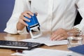 Businesswoman stamping documents Royalty Free Stock Photo