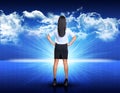 Businesswoman standing against blue landscape with Royalty Free Stock Photo