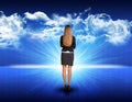 Businesswoman standing against blue landscape with Royalty Free Stock Photo