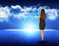 Businesswoman standing against blue landscape with Royalty Free Stock Photo