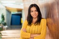 Businesswoman standing with arms folded in hallway Royalty Free Stock Photo