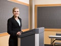 Businesswoman standing behind podium