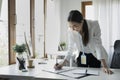 Businesswoman standing and checking reports at her office desk. Royalty Free Stock Photo