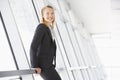 Businesswoman standing in corridor smiling