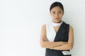 Businesswoman standing with crossed arms on white background Looking at the camera with a bad temper Royalty Free Stock Photo