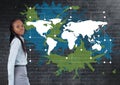 Businesswoman standing next to Colorful Map with paint splatters on wall background Royalty Free Stock Photo