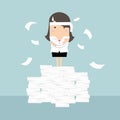 Businesswoman standing on paperwork