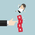 Businesswoman standing on shaky risk blocks by hand of manager. Royalty Free Stock Photo