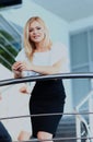 Businesswoman standing on the stairs in office. Royalty Free Stock Photo