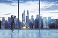 Businesswoman standing thinking in an empty big office room with big windows and night city view. Real estate and future success