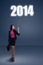 Businesswoman standing under new year 2014 Royalty Free Stock Photo