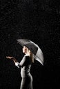 Businesswoman Standing Under Umbrella in rain