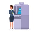 Businesswoman stands next to terminal, to transfer funds to card. Royalty Free Stock Photo