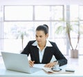 Businesswoman stirring coffee