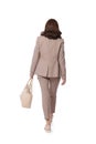 Businesswoman with stylish bag walking on white background, back view Royalty Free Stock Photo