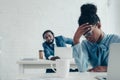 Businesswoman suffering from headache while sitting in office near colleague Royalty Free Stock Photo