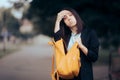 Woman Wiping her Forehead Sweating from Stress