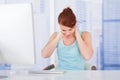Businesswoman Suffering From Neckache At Computer Desk Royalty Free Stock Photo
