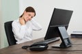 Businesswoman Suffering From Neckache At Desk