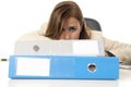 Businesswoman suffering stress and headache at office desk looking worried depressed and overwhelmed Royalty Free Stock Photo